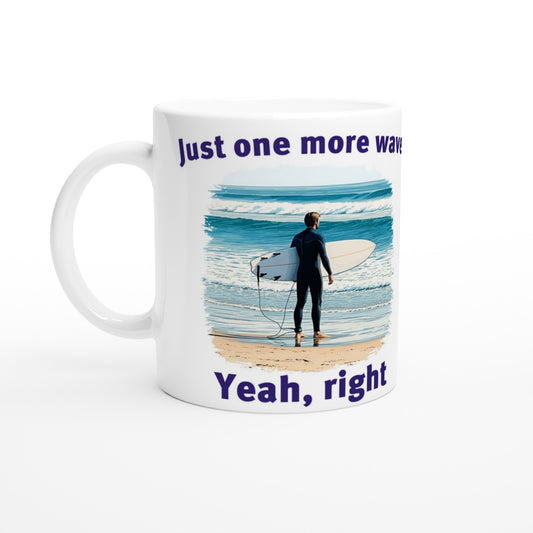White coffee mug. Stylized male surfer holding a surf board, standing on sand looking at the ocean

At the top are the words, "Just one more wave" in dark blue.

At the bottom are the words, "Yeah, right" in dark blue.